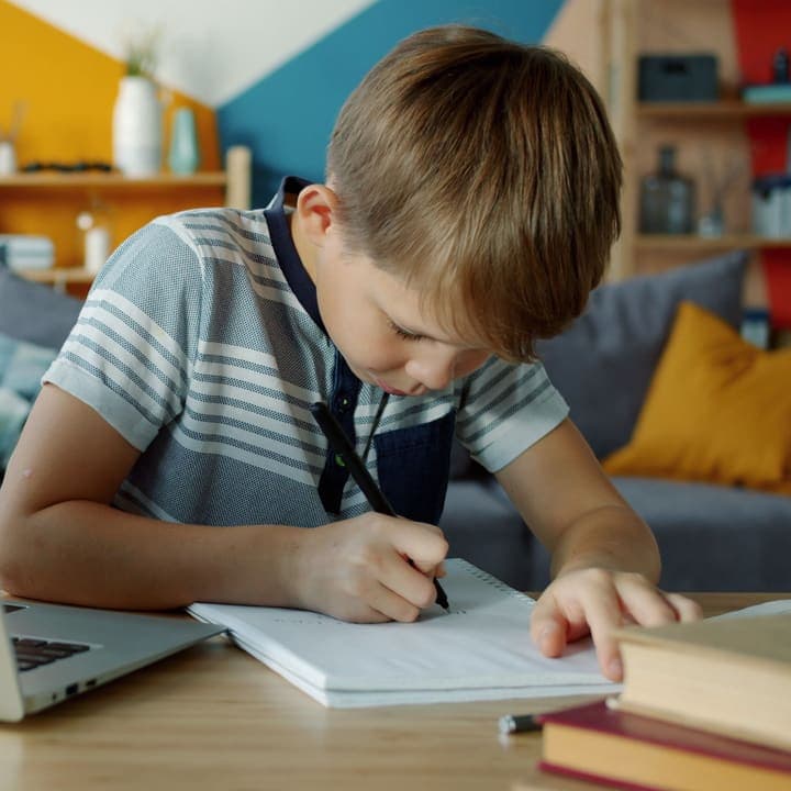A student taking notes during a lesson